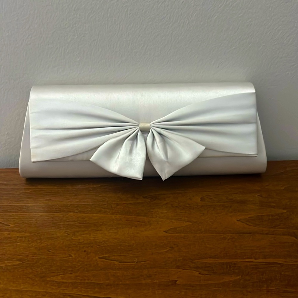 Silver clutch purse with bow detail on front